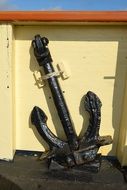 metal anchor near yellow wall
