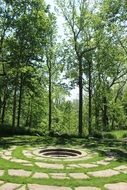 spiral stone walk path in summer park beneath trees