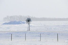 distant view of an ancient windmill in winter