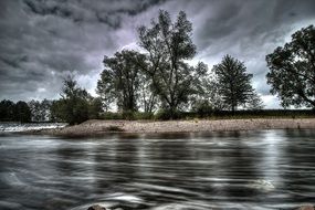 storm clouds reflected in the river in a mystical landscape