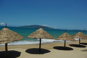 straw parasols on the beach in thailand