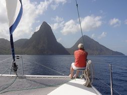 man on Sailboat at scenic coast, spain, Caribbean