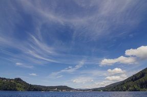 feather clouds over a mountain lake