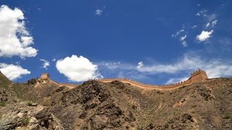 Beautiful Great Wall on the mountains at blue sky with white clouds