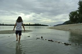 man walks along the bank of the danube