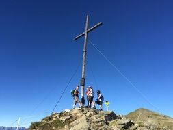 happy young people on mountain summit at Cross, austria, Fiss