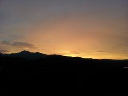 sun behind the mountain at sunset