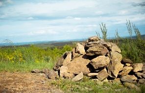 pile of stones on a green meadow