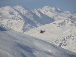 Helicopter flying over the beautiful snowy alps in Italy