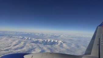 flying over the mountains in the clouds