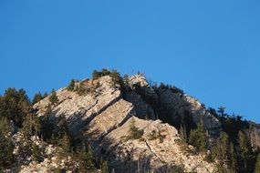 distant view of the cross on top of the alps on a sunny day