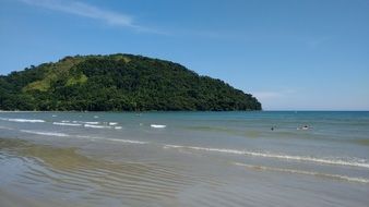 tropical beach on a background of green hill