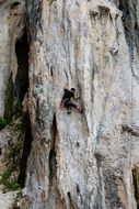 remote view of a climber on a rock