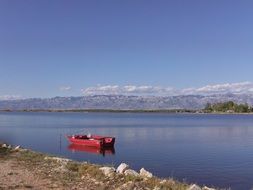 red rowing boat on the water