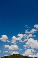 white clouds above a mountain peak in switzerland