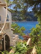 Beautiful villas near the blue water, among the green plants in Mallorca, Spain