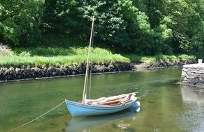 sailing boat is moored on the shore