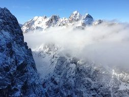 clouds in snowy mountains
