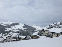 Snowy village on slope of mountain