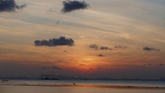 romantic sunset in the clouds above the beach