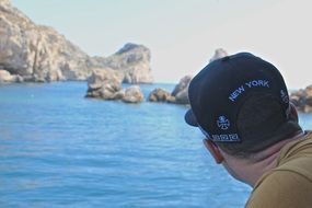 man watches the rocky coast