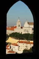 photo of a white church through a castle window in Lisbon