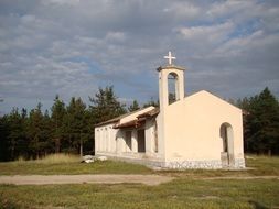 white church among meadows in the countryside