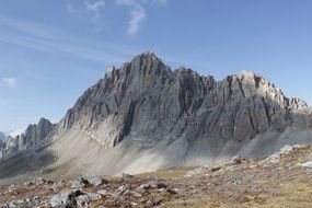 gray alpine mountains against the blue sky