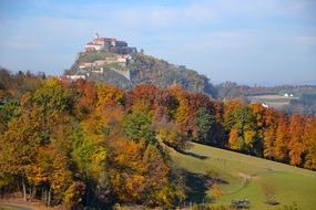 castle on the mountain near the autumn forest