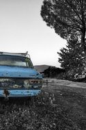 old damaged Blue car in Gray Landscape