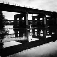 black and white photo of a steel railway bridge