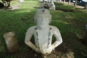 stone sculptures on the green grass in a park in costa rica