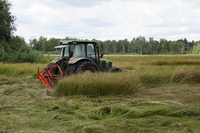 mower-tractor on green grass in a nature reserve