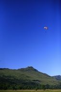 paragliding over the mountains on a sunny day