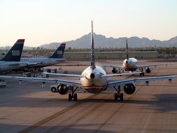 airplane on the runway against the background of the mountain