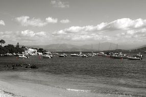 black and white photo of boats on the pier