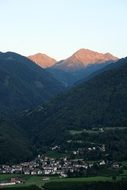 distant view of a village in the tyrol mountains at dusk