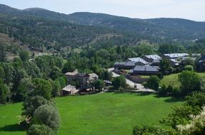 Beautiful panorama of a village with green trees in green mountains