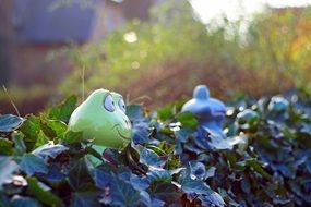 Beautiful colorful frog statues in the garden on blurred background