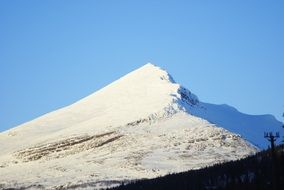 Beautiful snowy mountains at blue sky background in Sweden