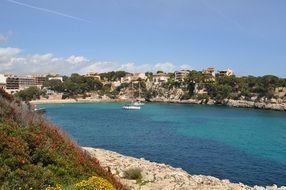 Holiday on the beautiful rocky coast with colorful plants in Mallorca, Spain