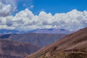 panoramic view of mountains under white clouds