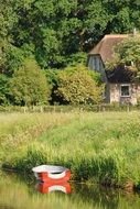 Landscape with the boat near the farm