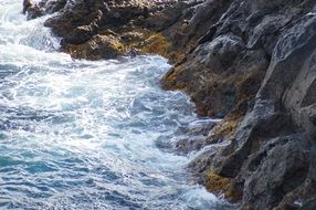 ocean waves beat against rocks on the shore of Tenerife