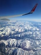 plane flies over the mountains of the Pyrenees