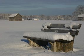 bench in the snow amid the winter landscape