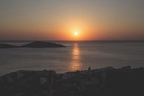 sunset over a village on the coast