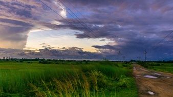 cloudy sky over green fields