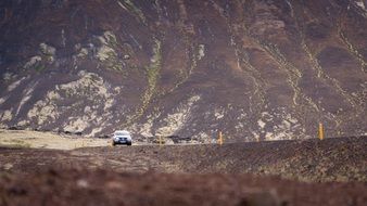 car on the road among high mountains