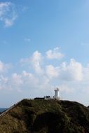 remote view of a lighthouse on a rock on jeju island